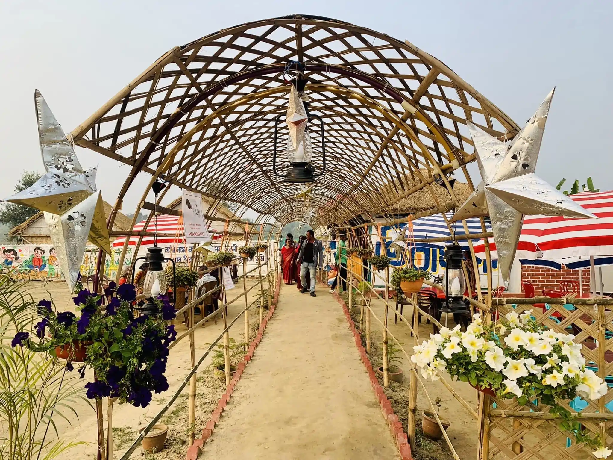 Bamboo arch corridor with lanterns and hanging flowers