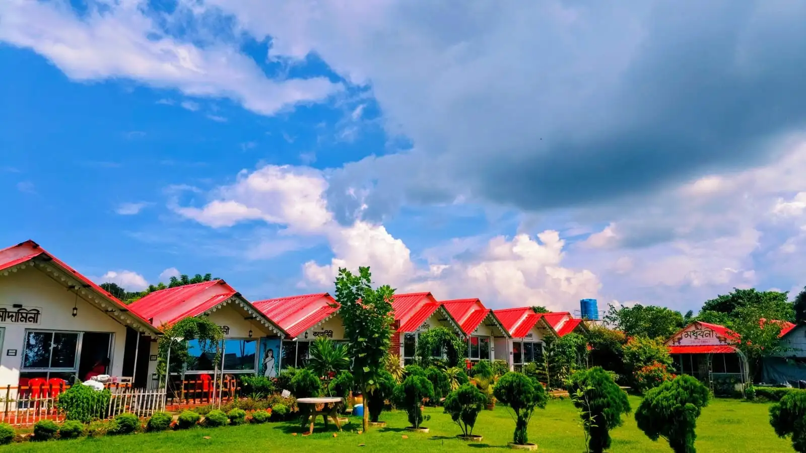 Tarangini Resort under bright blue skies with manicured lawns