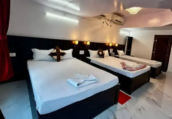 Family room with multiple beds at Tarangini