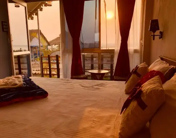 Room with sunset view through the window at Tarangini